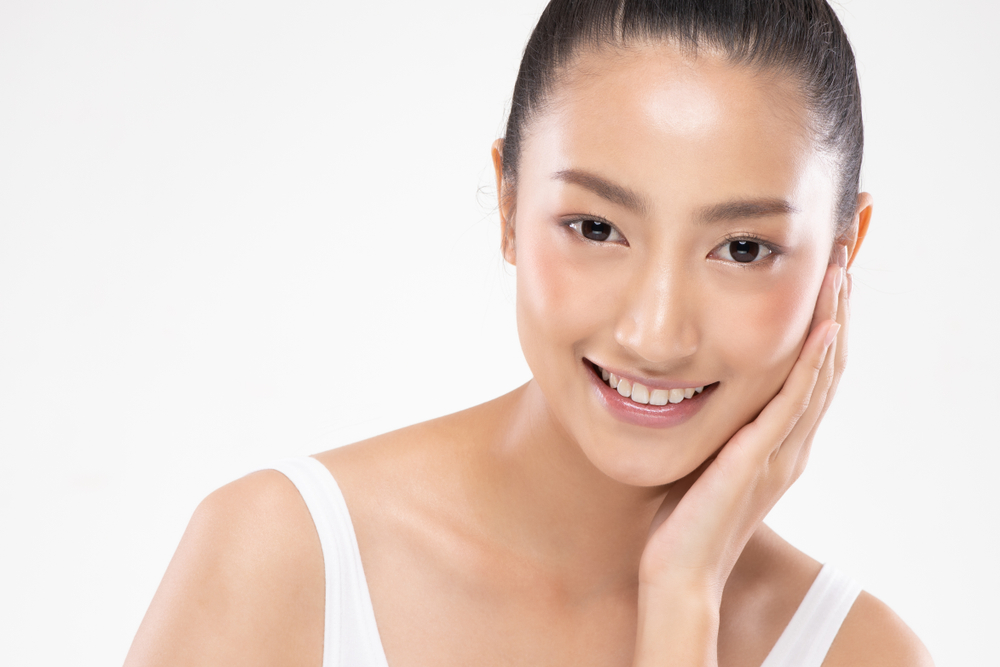 Beautiful,Asian,Woman,Touching,Soft,Cheek,Smile,With,Clean,And